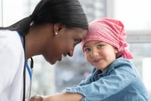 Nurse with little girl smiling.